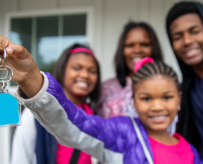 family holding a house key