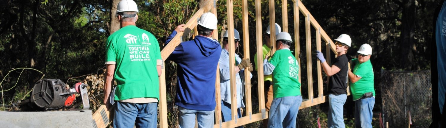 volunteers putting a frame up