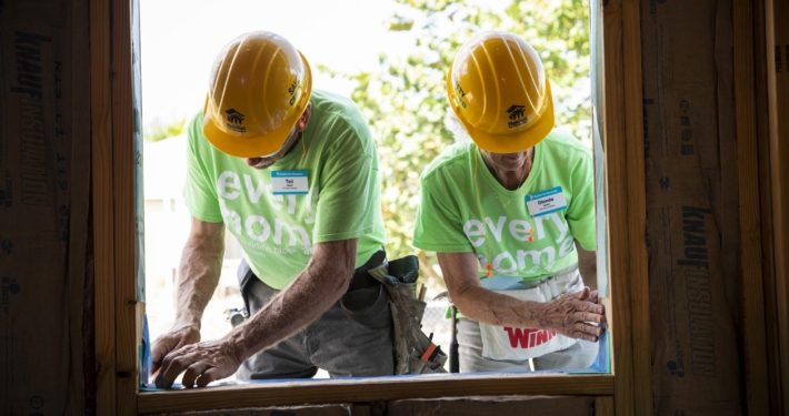 volunteers installing window tape