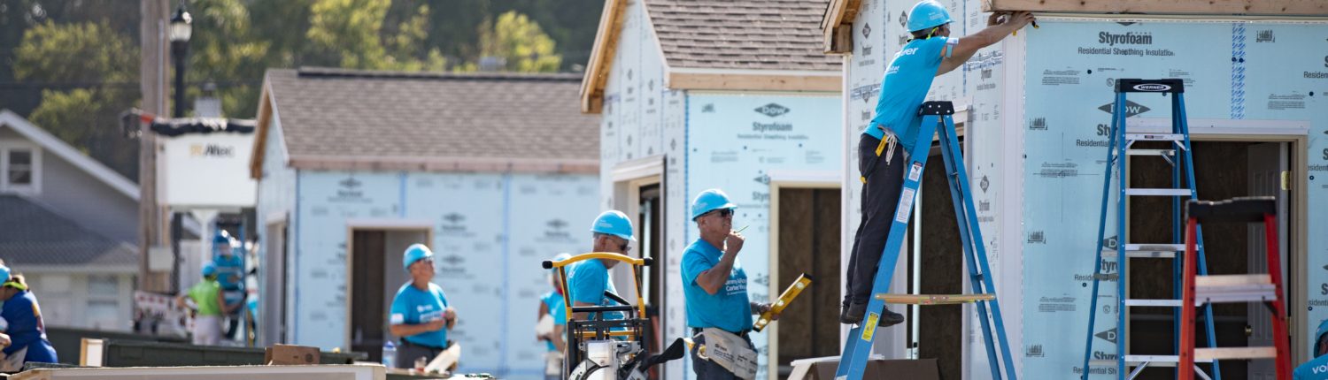 volunteers working on a house