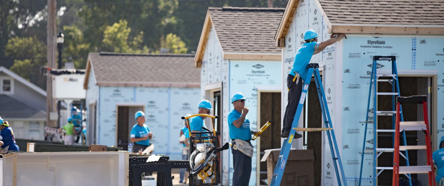 volunteers working on a house