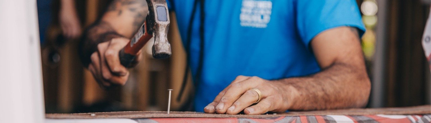 man hammering a nail