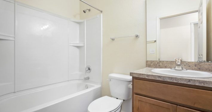 bathroom with shower, toilet, sink