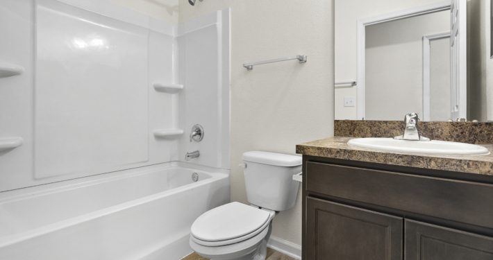 bathroom with tub, shower, toilet, and vanity