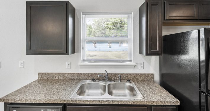 kitchen sink with window behind it