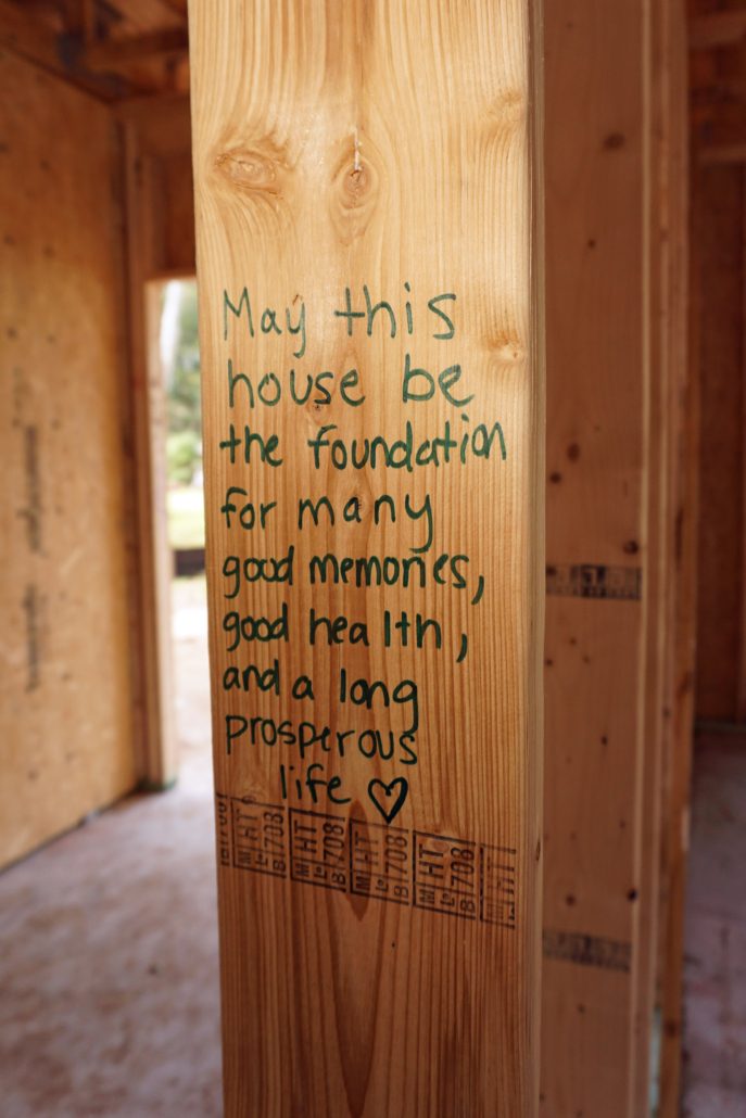 beam that reads "may this house be the foundation for many good memories, good health, and a long prosperous life"