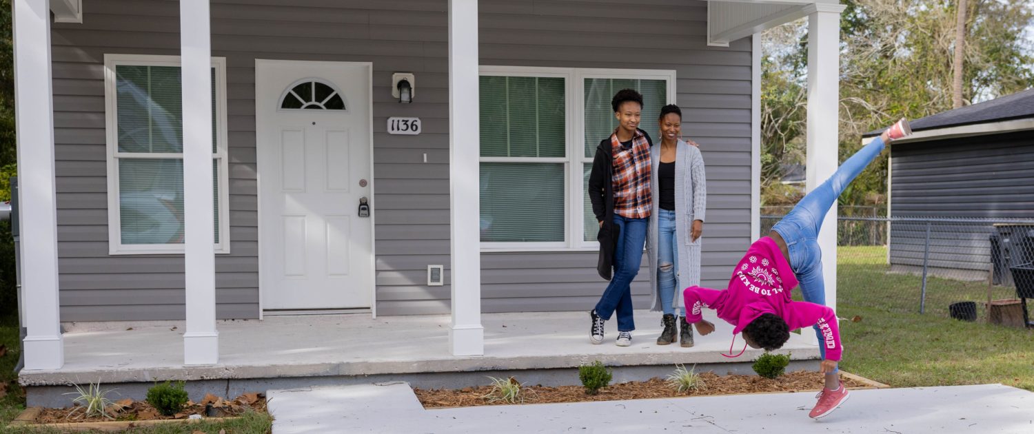 family standing outside of house