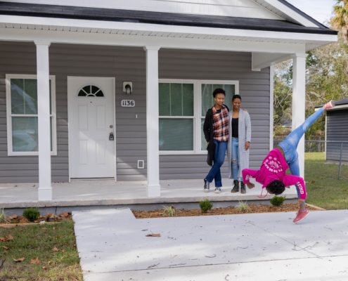 family standing outside of house