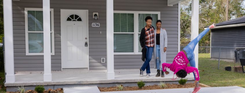 family standing outside of house